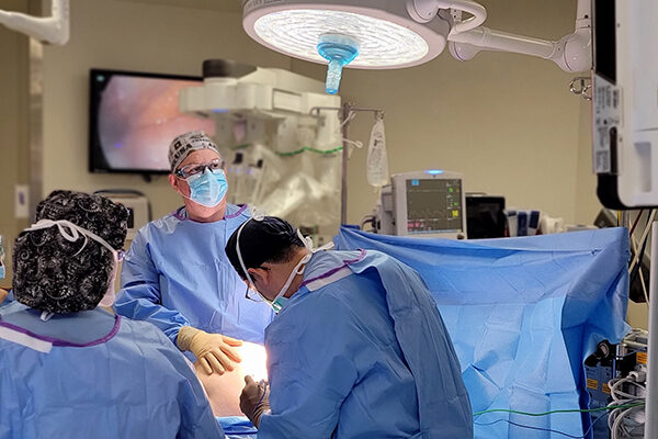 Dr. Fridley performing robotic surgery with teaching of surgical residents